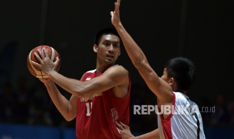 Center timnas basket Indonesia Christian Ronaldo Sitepu (memegang bola) saat tampil di SEA Games 2015 Singapura. Timnas basket putra meraih medali perak setelah kalah lawan Filipina di final.