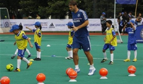 Chelsea's Branislav Ivanovic controls the ball during a soccer coaching clinic in Jakarta, Indonesia, Wednesday, July, 24, 2013. Chelsea is scheduled to play a friendly match against Indonesia on Thursday. 