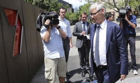 Chief Legal and Commercial Director of Seven Network Bruce Ian McWilliam (front right) arrives to speak to the media after Australian Federal Police raided their headquarters in Sydney, Australia, Tuesday, Feb. 18, 2014. 