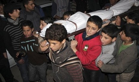 Children carry the body of a friend that was killed by shelling during heavy fighting between the Free Syrian Army and the forces of Syrian President Bashar al Assad in Jobar district of Damascus January 25, 2013. 