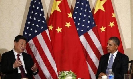 China's President Xi Jinping speaks during his meeting with U.S. President Barack Obama (R), on the sidelines of a nuclear security summit, in The Hague March 24 2014.