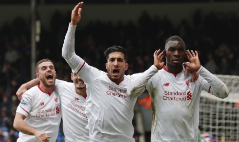 Christian Benteke celebrates with team mates after scoring the second goal for Liverpool