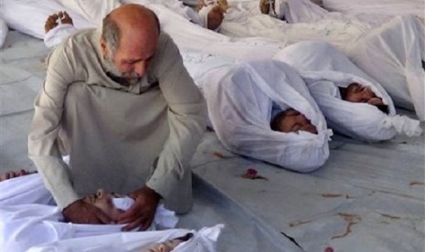 Citizen journalism image provided by the  which has been authenticated based on its contents and other AP reporting, shows a Syrian man mourning over a dead body after an alleged poisonous gas attack fired in Douma town, Damascus, Syria. 