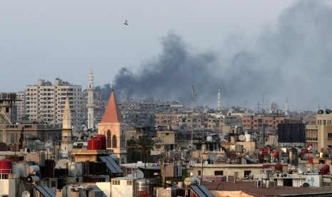 Columns of smoke rising from heavy shelling in the Jobar neighborhood in west Damascus, Syria, Thursday, Aug. 22, 2013. 