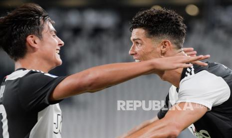 Cristiano Ronaldo  merayakan dengan rekan setimnya Paulo Dybala setelah mencetak gol pada pertandingan sepak bola Serie A Italia antara Juventus dan Lazio di stadion Allianz di Turin, Italia, Senin (20/7/2020).