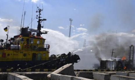 Dalam foto yang disediakan oleh Kantor Pers Balai Kota Odesa, petugas pemadam kebakaran memadamkan api di pelabuhan setelah serangan rudal Rusia di Odesa, Ukraina, Sabtu, 5 Juni 2022. Rudal Rusia menghantam pelabuhan Laut Hitam Ukraina di Odesa hanya beberapa jam setelahnya. Moskow dan Kyiv menandatangani kesepakatan untuk memungkinkan ekspor biji-bijian dilanjutkan dari sana.