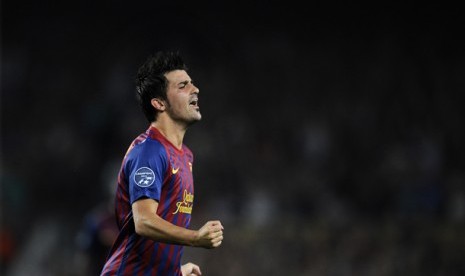 David Villa melakukan selebrasi usai menciptakan gol ke gawang AC Milan dalam pertandingan Liga Champions Grup H di Nou Camp, Barcelona, Spanyol, 13 September 2011.  