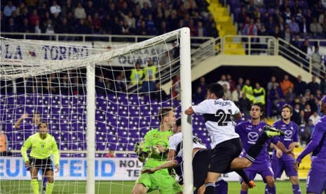 Defender Parma, Massimo Gobbi (tengah), melepaskan sundulan yang mengoyak gawang Fiorentina di laga Serie A Italia di StadionArtemio Franchi, Florentina, Senin (30/9). 