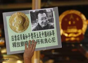 Demonstran pro demokrasi mengangkat foto Liu Xiaobo dengan tulisan \