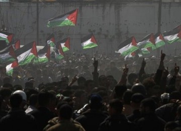 Demonstrators wave Palestinian flags during a rally on 