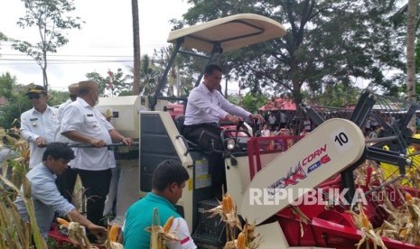 Dengan menggunakan alat pertanian, traktor, Mentan Andi Amran  Sulaiman melakukan panen raya jagung, di Kabupaten Gorontalo, Provinsi  Gorontalo, Rabu (30/1). 