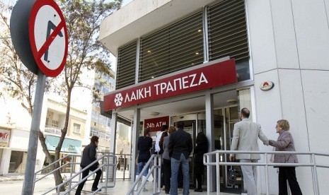 Depositors wait to enter a branch of Laiki Bank in Nicosia March 29, 2013. Cyprus claims it has 