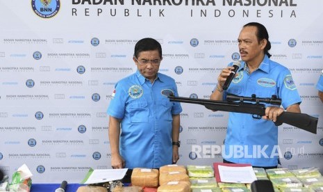 Deputi Pemberantasan BNN Irjen Pol Arman Depari (kanan) menunjukan barang bukti senjata api saat rilis kasus narkoba jaringan internasional di BNN, Jakarta, Rabu (14/11/2018). 