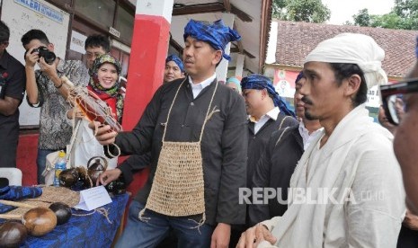 Direktur Enterprise dan Business Service PT Telkom Indonesia Muhammad Awaluddin (kedua dari kanan) membeli madu produksi UKM kampung Baduy disaksikan sesepuh Baduy Dalam Ayah Mursid (kanan) di Kampung Ciboleger Kenekes, Kab Lebak, Banten, Jumat (19/8)