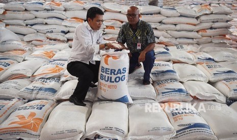 Direktur Operasional dan Pelayanan Publik Bulog Karyawan Gunarso (kiri) didampingi Kabid Operasional dan Pelayanan Publik Divre Jakarta Banten Bahtera Pinem (kanan) memeriksa kualitas beras Bulog di Gudang Bulog Kelapa Gading, Jakarta, Kamis (24/5).