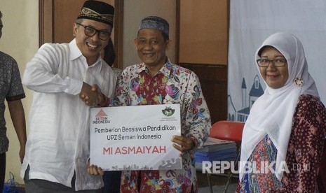 Direktur SDM dan Hukum Semen Indonesia Agung Yunanto (kiempat dari kiri) bersama perwakilan siswa penerima beasiswa di Gresik, Jum’at (11/1). 