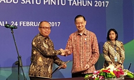 Direktur Utama BPJS Ketenagakerjaan Agus Susanto (kiri) bertukar nota kerja sama dengan Kepala BKPM Thomas Lembang di Nusa Dua, Bali, Jumat (23/2).