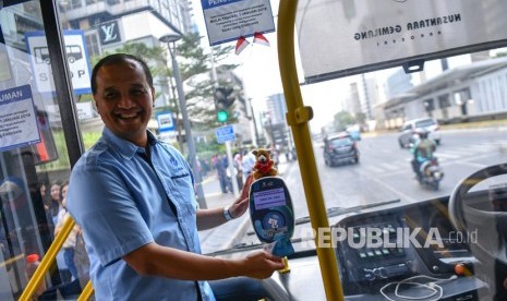 Direktur Utama PT Transportasi Jakarta (Transjakarta) Agung Wicaksono mencoba penggunaan alat pembayaran Tap On Bus (TOB) saat sosialisasi di bus non-BRT di Halte Transjakarta Bundaran HI, Jakarta, Selasa (6/8/2019).