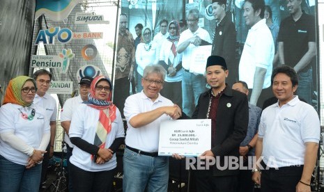 Dirut Bank BJB Yuddy Renaldi (tengah) secara simbolis memberikan Kredit Usaha Rakyat (KUR) pada Festival Literasi Keuangan (FLK), di Cikapundung River Spot, Kota Bandung, Sabtu (26/10).