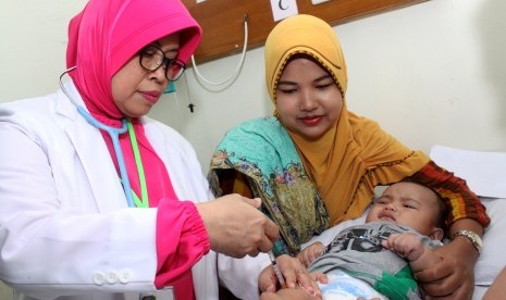 Dokter menyuntikkan vaksin kepada balita yang terpapar vaksin palsu saat melakukan vaksinasi ulang, di rumah sakit Rawalumbu, Bekasi, Jawa Barat, Selasa (26/7). 