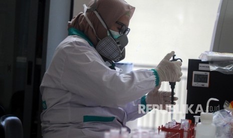 Dokter patologi klinik memeriksa sampel media pembawa virus corona untuk penelitian di laboratorium.