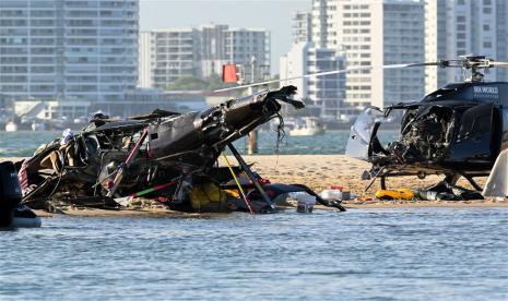  Dua helikopter terlihat setelah tabrakan di dekat Seaworld, di Gold Coast, Australia, Senin, 2/1/2023. Empat orang tewas dan 13 lainnya terluka setelah dua helikopter bertabrakan sebelum satu menabrak Broadwater di Gold Coast.