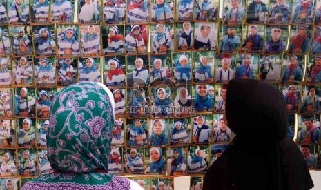  Dua orang jamaah calon haji kloter 29 asal DKI Jakarta mengamati foto yang dipajang di halaman Asrama Haji, Pondok Gede, Jakarta Timur, Rabu (10/10). (Agung Supriyanto/Republika)