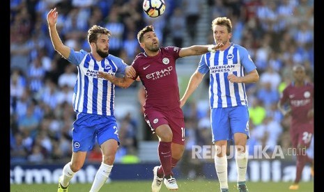 Dua pemain Brighton & Hove Albion Markus Suttner (kiri) dan Dale Stephens (kanan) berebut bola dengan striker Manchester City  Sergio Aguero pada pertandingan Liga EPL di Brighton, Inggris, Sabtu (12/8) malam.