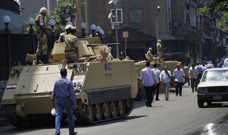 Egyptian military soldiers stand guard atop armored personnel carriers at Maspero, an Egypt's state tv and radio station in Cairo, on Saturday.