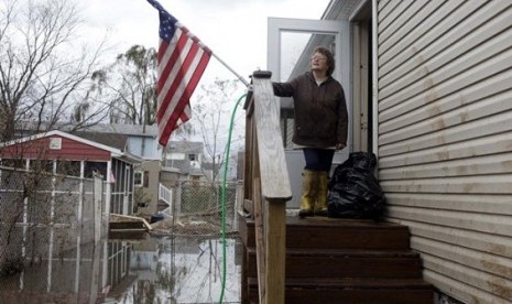 Eileen Miley takes a break from cleaning her home that was destroyed by flooding during Storm Sandy in Staten Island, New York, Thursday, Nov. 1, 2012.   