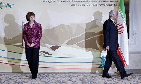 EU foreign policy chief Catherine Ashton, left, smiles, as Secretary of Iran’s Supreme National Security Council Saeed Jalili walks away, after a photo call at a start of high-level talks between world powers and Iranian officials in Almaty, Kazakhstan on 