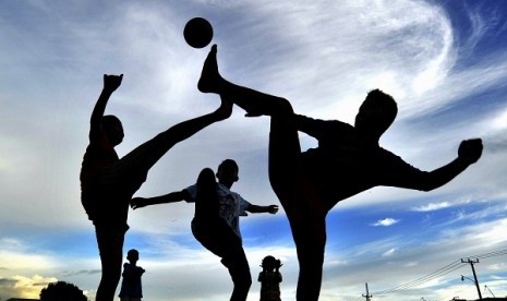 Euro fever hits Indonesia as seen in Makassar, South Sulawesi, some kids play soccer.  