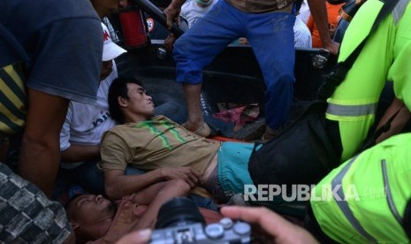 Evakuasi Bolaang Mangondow. Petugas merawat salah seorang penambang yang selamat dari lokasi Pertambangan Emas Tanpa Izin (PETI) Desa Bakan, Kecamatan Lolayan, Kabupaten Bolaang Mongondouw, Sulawesi Utara, Rabu (27/2/2019). 