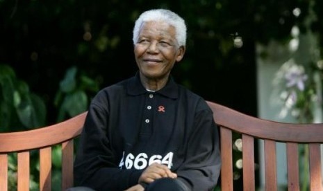 File photo of Nelson Mandela smiling at a news conference near the small Southern Cape province town of George.