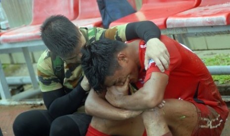 Fisioterapis PS TNI Matias Ibo (kiri) menenangkan pesepakbola Semen Padang FC, Irsyad Maulana (kanan), usai pertandingan terakhir Liga 1 Gojek Traveloka di Stadion GOR H Agus Salim, Padang, Sumatera Barat, Ahad (12/11). Meski pada pertandingan tersebut Semen Padang menang melawan PS TNI dengan skor 2-0 tapi hasi itu tetap tidak menyelamatkan Semen Padang dari zona degradasi. 