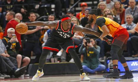 Forward Toronto Raptors Pascal Siakam (kiri) dijaga oleh guard Utah Jazz Mike Conley.