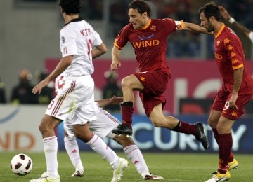 Francesco Totti (dua kanan), striker AS Roma, menggiring bola dengan dibayangi bek AC Milan, Alessandro Nesta.