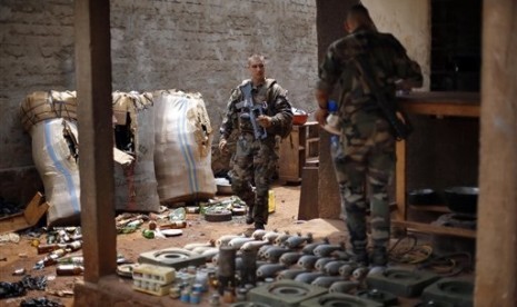 French soldiers search a house used as an armed cache in the Christian sector of PK12, the last checkpoint at the exit of the town, in Bangui, Central African Republic Tuesday Feb. 11, 2014. 