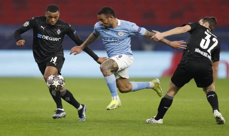 Leg pertama. Gabriel Jesus dari Manchester City, tengah, ditantang oleh Alassane Plea dari Moenchengladbach, kiri dan Florian Neuhaus dari Moenchengladbach selama pertandingan leg pertama babak 16 besar Liga Champions antara Borussia Monchengladbach dan Manchester City di stadion Puskas Arena di Budapest, Hongaria, Rabu, Feb. 24, 2021.