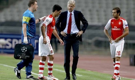 Gelandang Arsenal, Mikel Arteta (dua kiri), ditarik keluar lantaran mengalami cedera saat menghadapi Besiktas di leg pertama babak playoff Liga Champions di Istanbul, Turki, Selasa (19/8). 