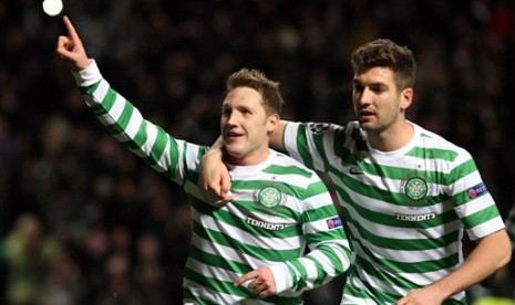 Gelandang Glasgow Celtic, Kris Commons (kiri), merayakan golnya ke gawang Spartak Moskow dari titik putih bersama Charlie Mulgrew. Gol tersebut mengantarkan Celtic menang 2-1 di Celtic Park dan meloloskan klub Skotlandia itu ke 16 besar Liga Champions.