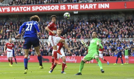 Gelandang Manchester United, Marouane Fellaini (kiri) menanduk bola masuk ke gawang Middlesbrough pada laga Liga Primer Inggris, di stadion Riverside, Ahad (19/3). United unggul 1-0 pada babak pertama.