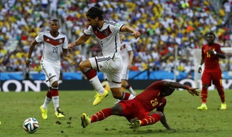 Ghana's Kwadwo Asamoah fights for the ball with Germany's Sami Khedira (top) during their 2014 World Cup Group G soccer match at the Castelao arena in Fortaleza June 21, 2014