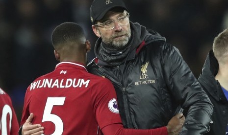 Georginio Wijnaldum (kiri) memeluk pelatih Liverpool Juergen Klopp seusai laga kontra Leicester City.