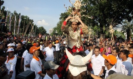 Governor of Jakarta Joko Widodo or Jokowi rides a horse and wears carnival costume during an opening of Jakarnaval in Jakarta on Sunday. 