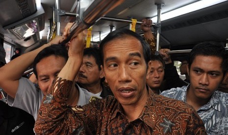 Governor of jakarta, Joko Widodo, takes Transjakarta after launcing its new corridor connecting Tanjung Priok and Pluit in Jakarta on Thursday. 