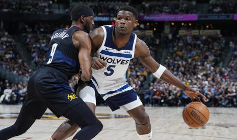 Guard Minnesota Timberwolves Anthony Edwards (kanan) membawa bola menuju keranjang saat forward Denver Nuggets Justin Holiday bertahan pada Game 2 seri playoff putaran kedua NBA, Selasa, (7/5/2024) WIB.