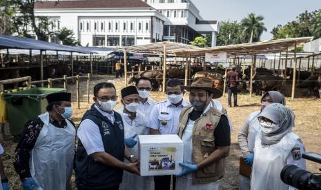 Gubernur DKI Jakarta Anies Baswedan (kedua kiri) memberikan donasi obat hewan kepada pedagang Blisapi Dudut Andianto (kedua kanan) saat meninjau penjualan sapi kurban di Blisapi, Penggilingan, Cakung, Jakarta Timur, Jumat (1/7/2022). Kunjungan Gubernur DKI Jakarta Anies Baswedan itu bertujuan untuk memastikan kondisi kesehatan hewan kurban yang telah tiba di Jakarta.