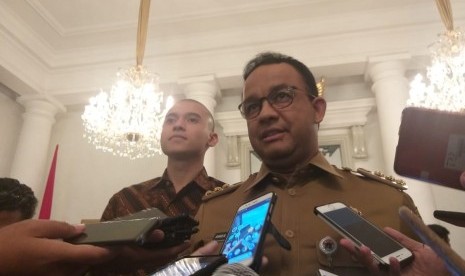 Gubernur DKI Jakarta Anies Rasyid Baswedan (kanan) dan Direktur PT Indonesia Lebih Aman Muhammad Fardhan (kiri) di Balai Kota, Jakarta Pusat, Selasa (12/3).