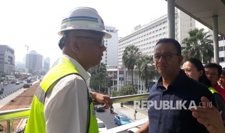 Gubernur DKI Jakarta Anies Rasyid Baswedan meninjau proyek penataan trotoar dan jalan di ruas Jalan Sudirman hingga Jalan MH Thamrin, Jakarta Pusat, Ahad (22/7).